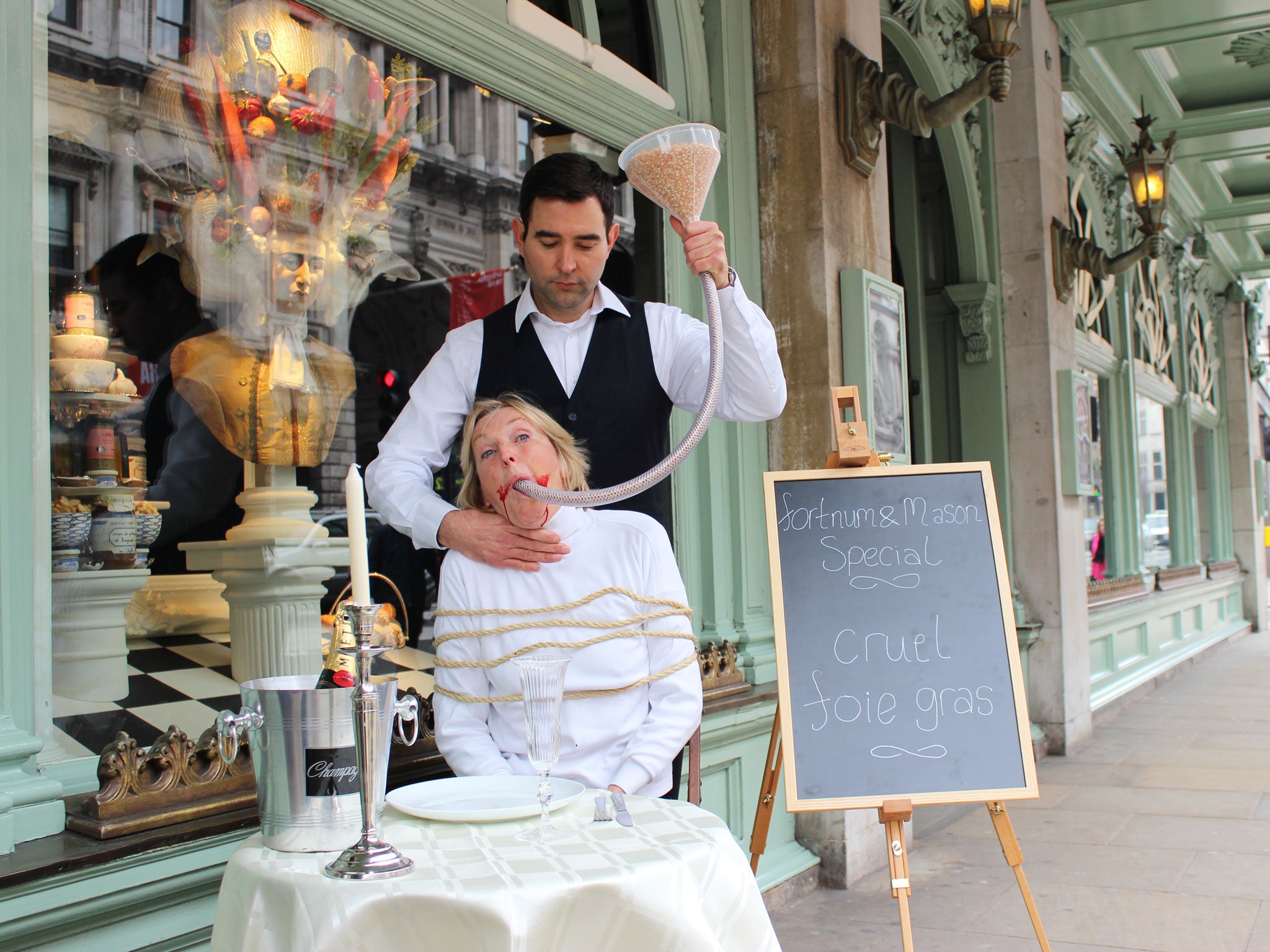 Ingrid Newkirk outside Fortnum & Mason with a bloodied mouth and feeding tube