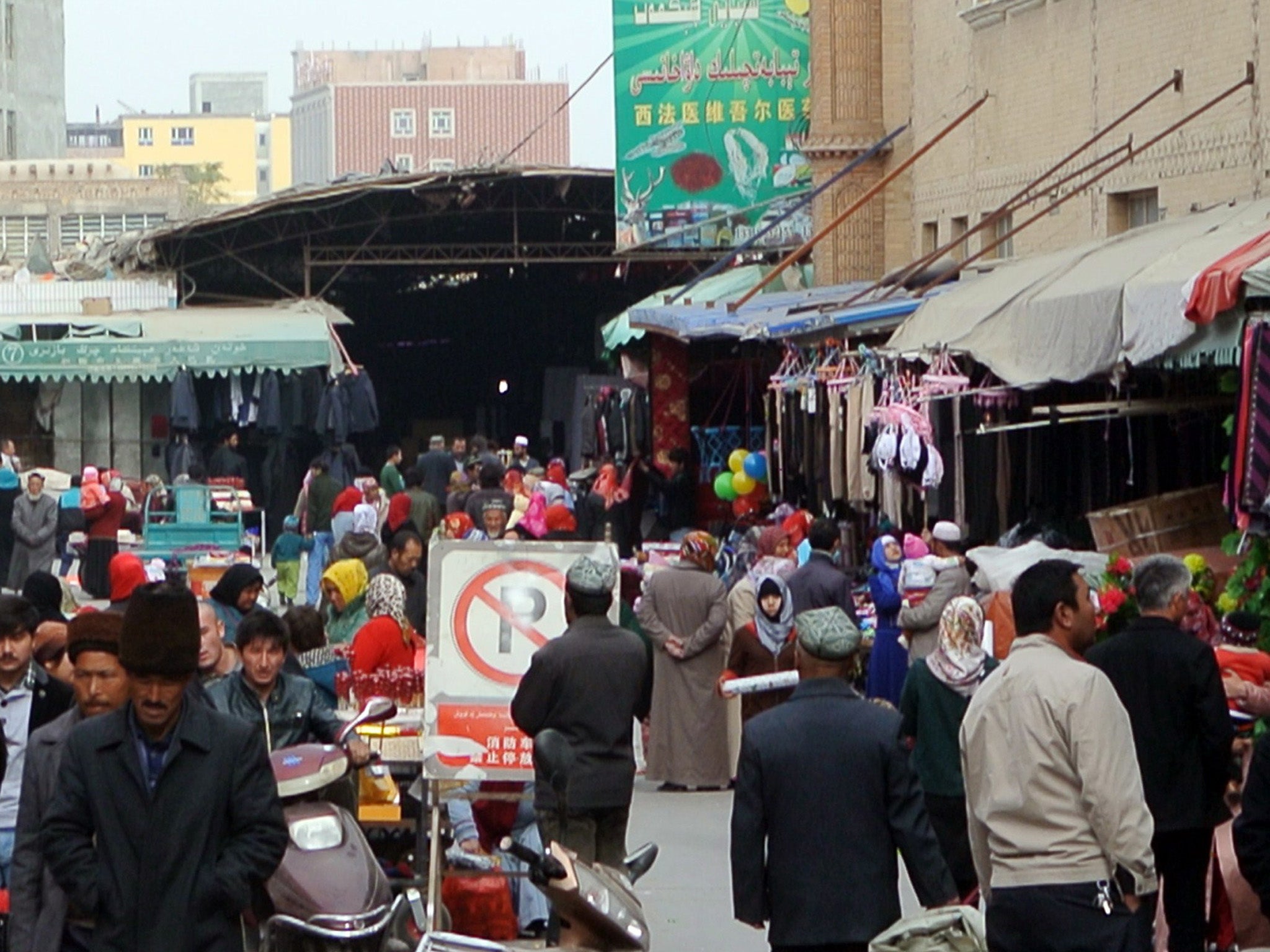 A crowd of mainly Uighur shop at a bazaar in China's Xinjiang region