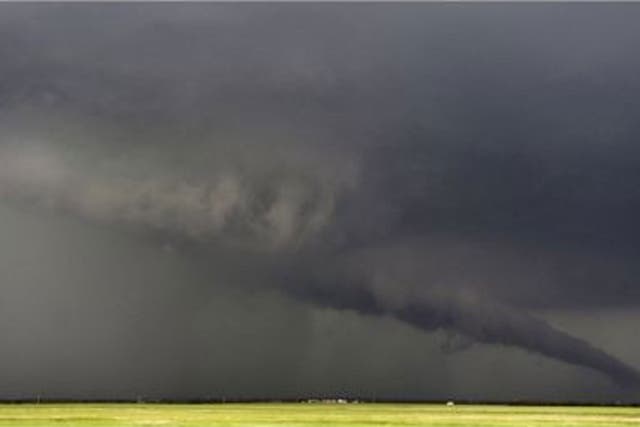 File: The funnel of a tornado touches down during a thunderstorm in May near South Haven, Oklahoma