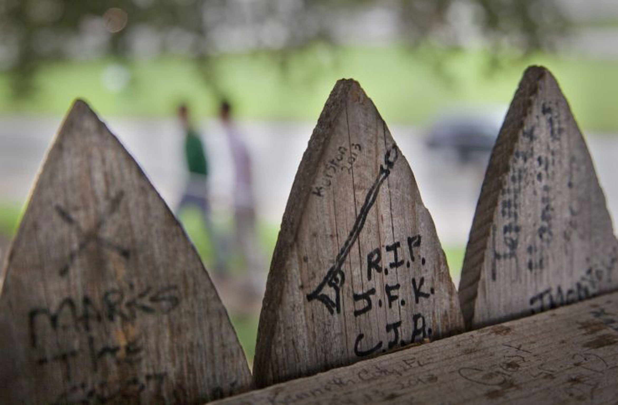 RIP JFK: the stockade fence that surrounds the Grassy Knoll is covered with messages and drawings left there by visitors