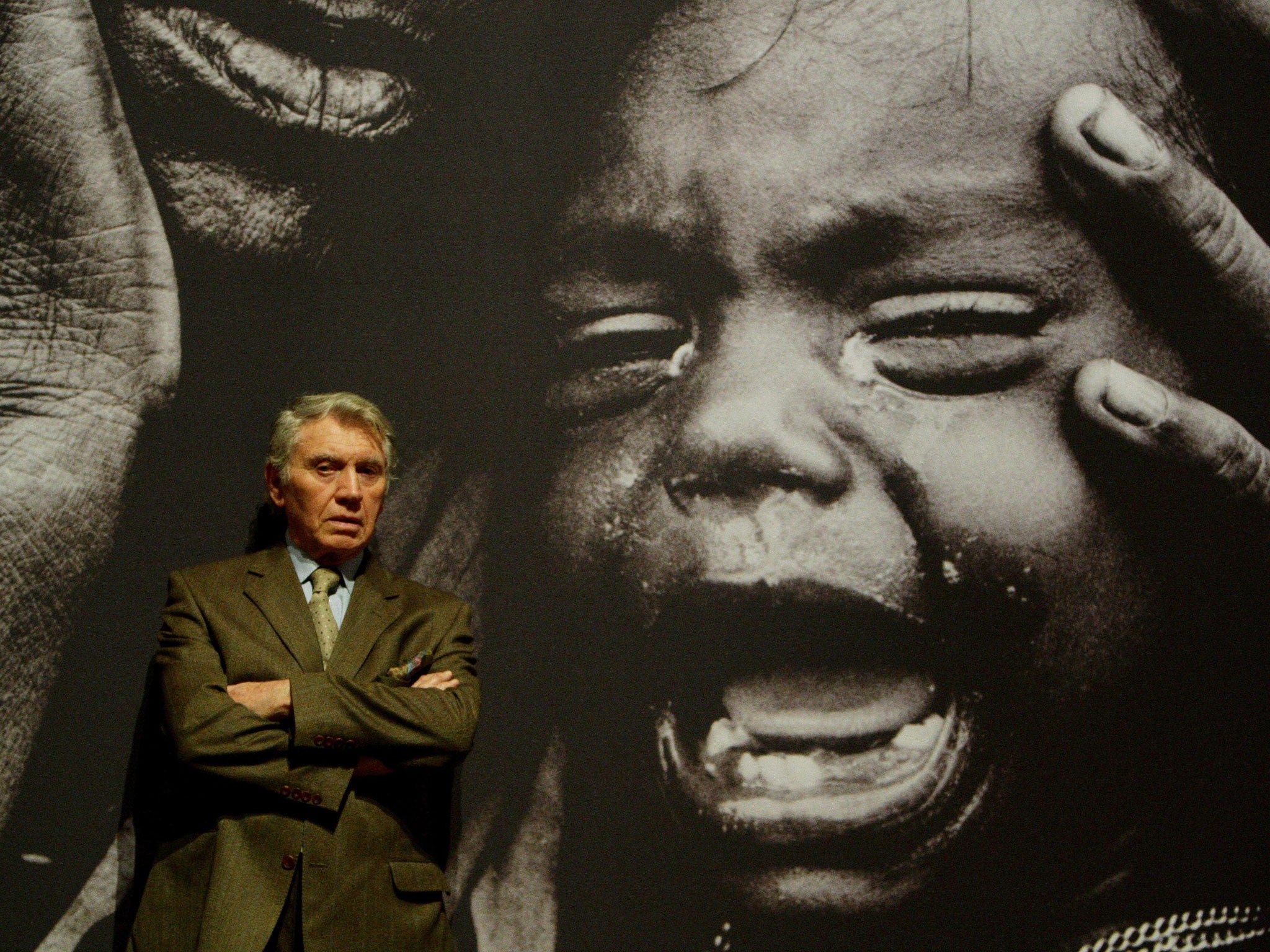 Don McCullin, pictured in front of one of his powerful war pictures, says he wishes he had spent more of his life taking photographs closer to home