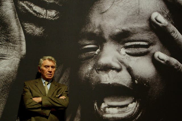 Don McCullin, pictured in front of one of his powerful war pictures, says he wishes he had spent more of his life taking photographs closer to home
