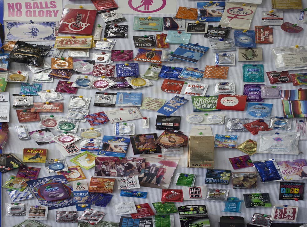 A wall is covered in different condom brands