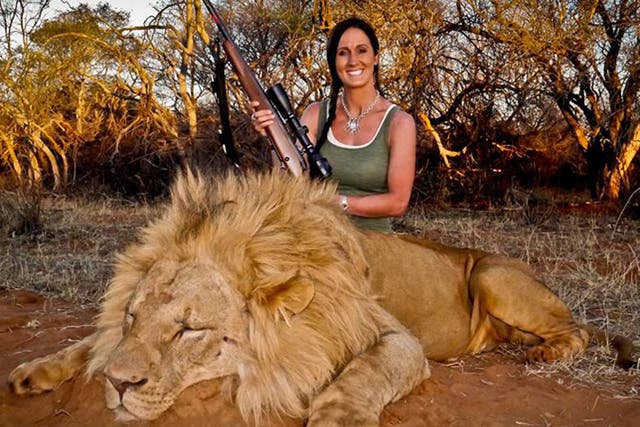 Melissa Bachman poses with a dead male lion in South Africa