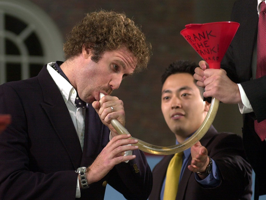 Actor Will Ferrell shows Harvard students how to use a beer funnel