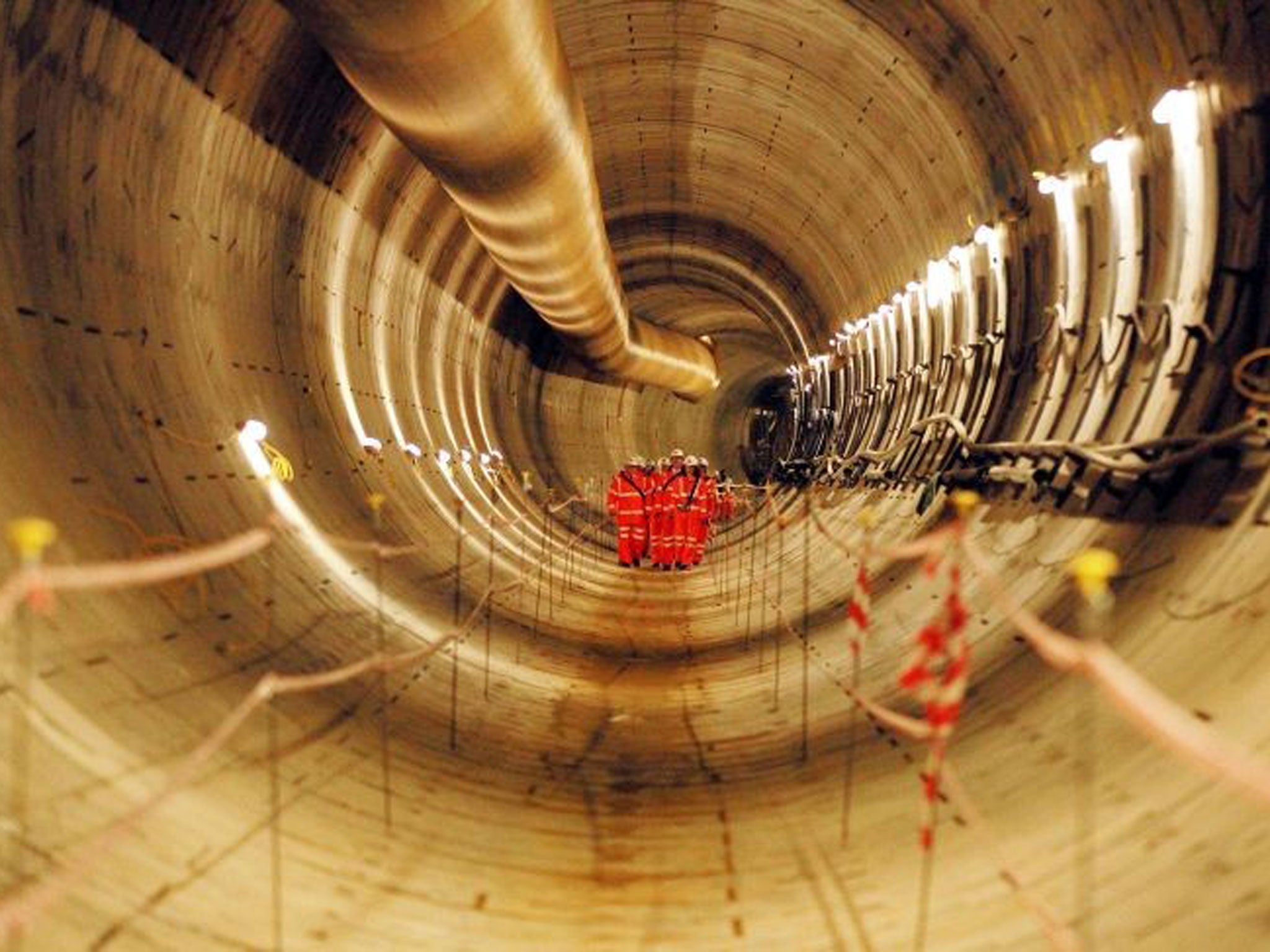 Crossrail workers, inspect the first completed section of Crossrail tunnel