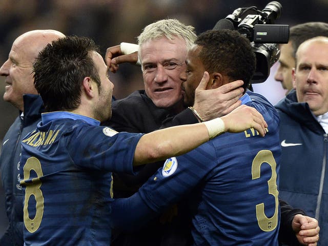 Didier Deschamps (centre) celebrates with Mathieu Valbuena  (left) and Patrice Evra