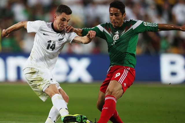 Storm Roux of New Zealand competes with Aldo De Nigris Guajardo of Mexico during the second leg of the Fifa World Cup qualifier 