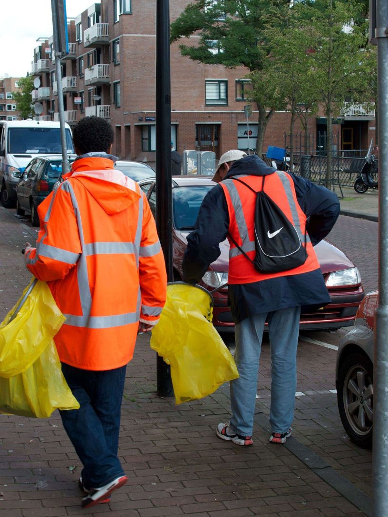 Chronic alcoholics clean a street in Amsterdam. The initiative of street cleaning in exchange for beer is sponsored by the De Regenboog (Rainbow) Foundation, mostly supported by donations and state subsidies