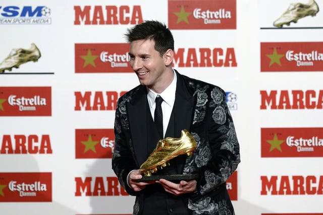 Barcelona's Argentinian forward Lionel Messi poses after receiving his Golden Boot 2013 award, presented to Europes best goal scorer of the 2012-2013 season