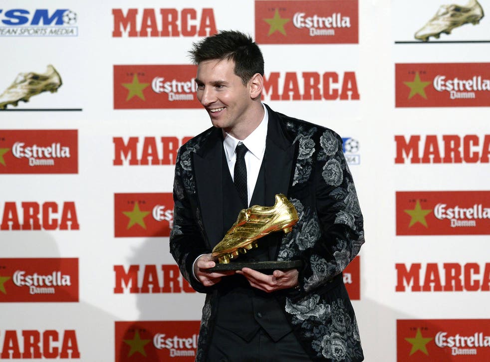 Barcelona's Argentinian forward Lionel Messi poses after receiving his Golden Boot 2013 award, presented to Europes best goal scorer of the 2012-2013 season