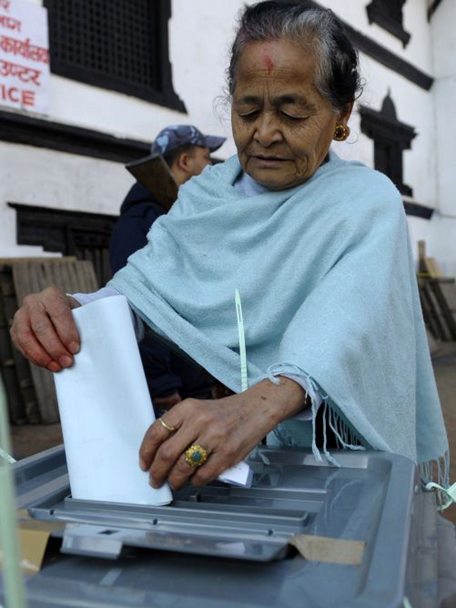 A Nepalese voter casts her ballot at a polling station in Kathmandu