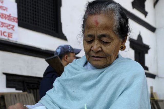 A Nepalese voter casts her ballot at a polling station in Kathmandu
