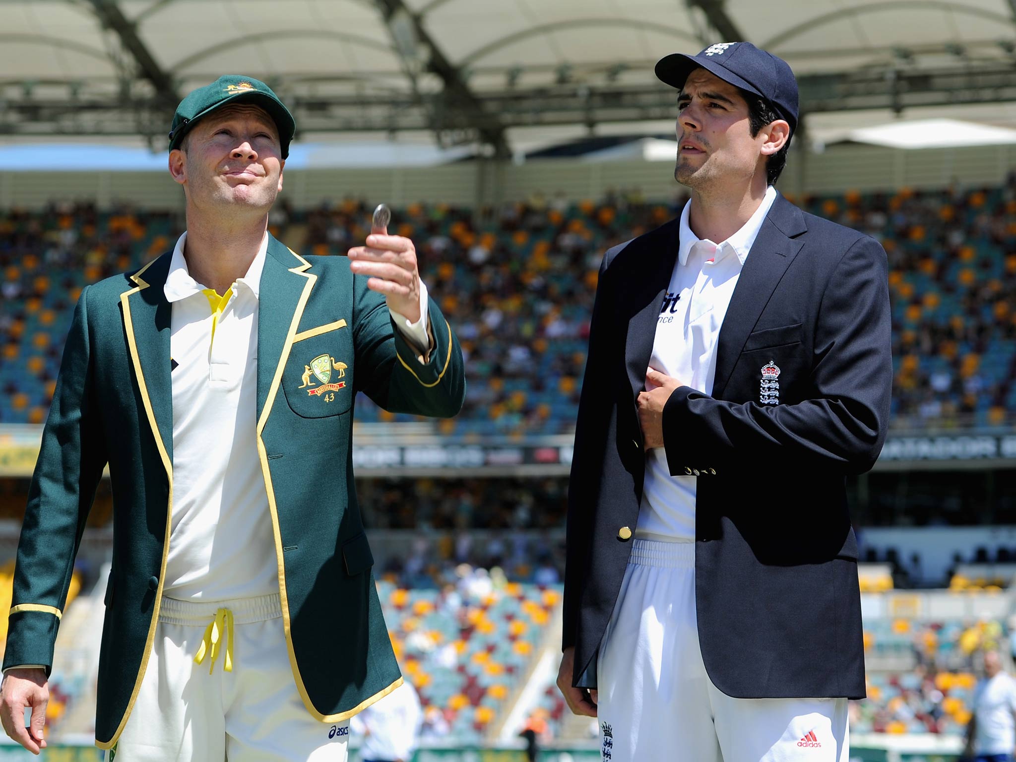 Australian captain Michael Clarke tosses the coin alongside England captain Alastair Cook ahead of day one of the First Ashes Test match between Australia and England at The Gabba