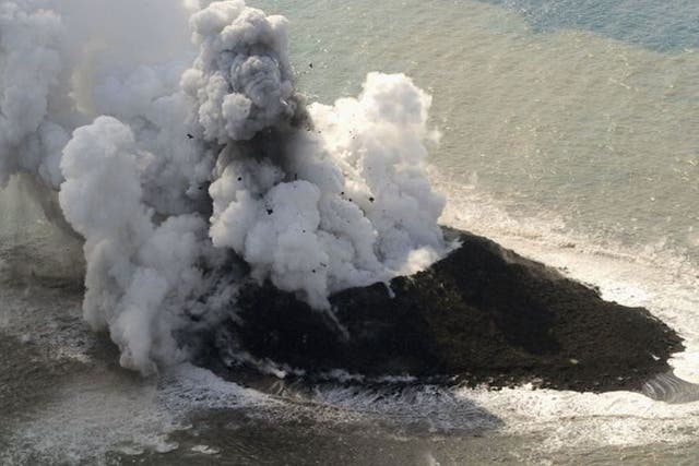 Smoke from an erupting undersea volcano forms a new island off the coast of Nishinoshima