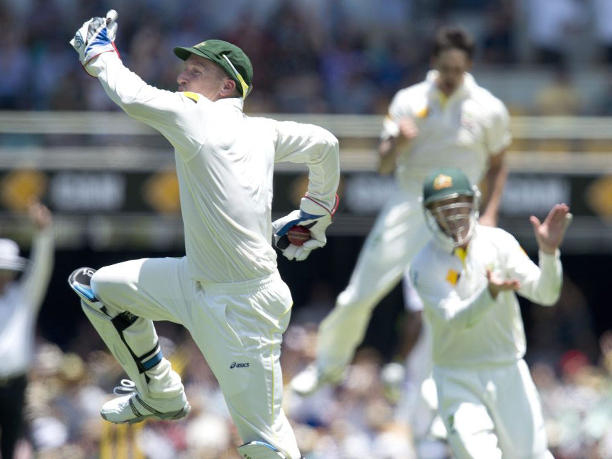 Australian wicket keeper Brad Haddin (left) celebrates after catching out England's batsman Jonathan Trott (not pictured) from the bowling of Mitchell Johnson on day two