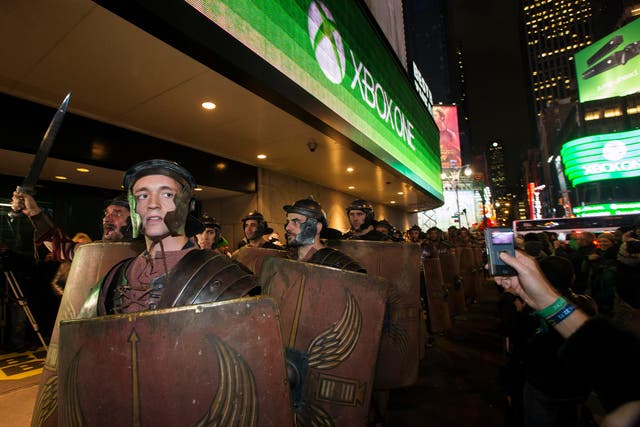 Actors dressed as characters from the Xbox One game "Ryse: Son of Rome" walk through Times Square as they arrive at an event celebrating the midnight launch of the Xbox One in New York.