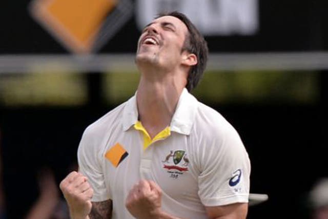 Australia's Mitchell Johnson celebrates taking the wicket of England's Graeme Swann for 0 