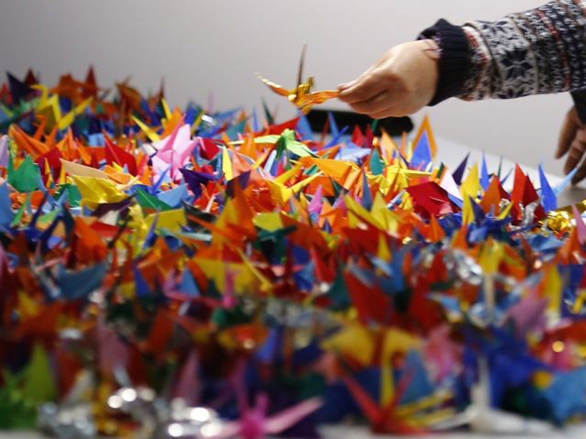 Paper cranes are supposed to be ephemeral, left to disintegrate and then to release their wishes for peaces