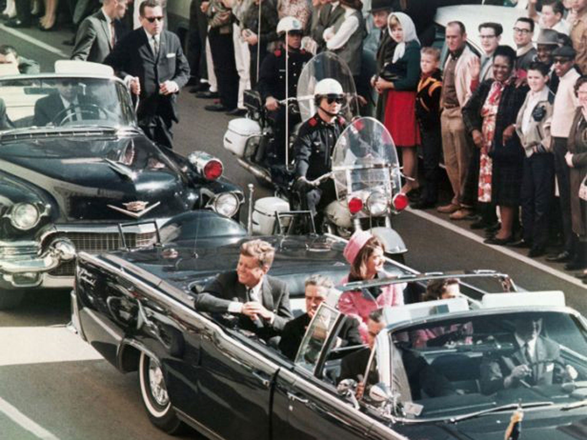 President John F. Kennedy's motorcade travels through Dallas on 22 November 1963