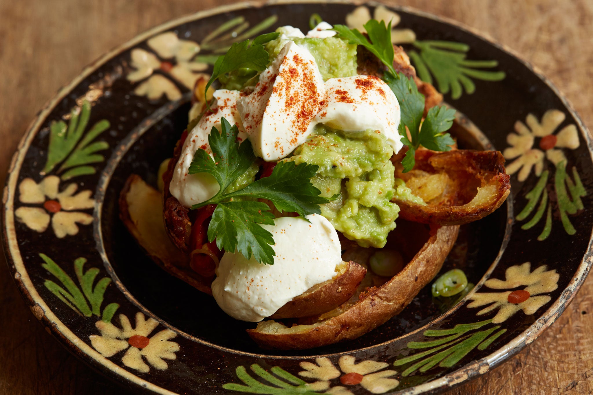 Fried potato skins with spiced chicken, guacamole and sour cream