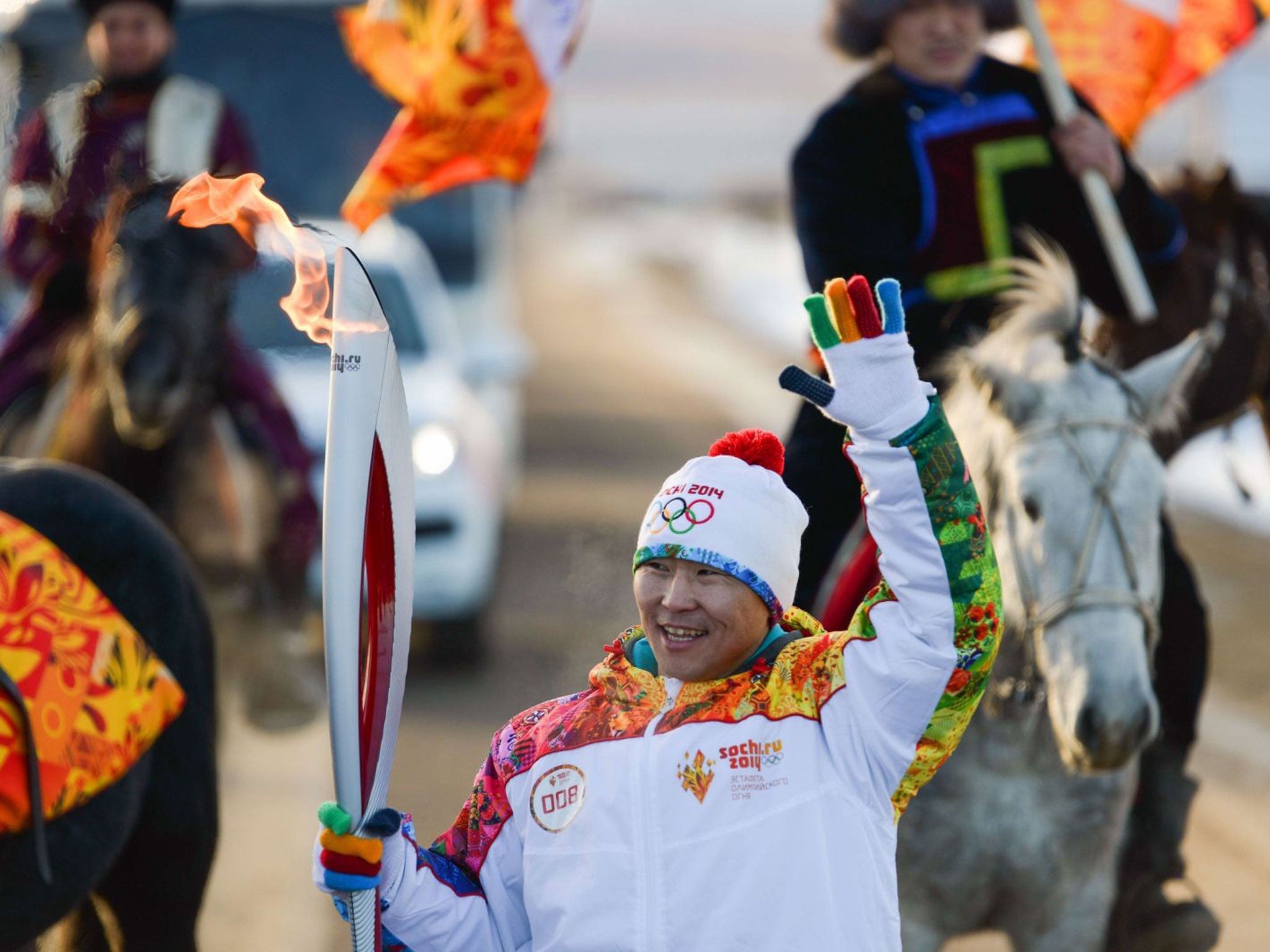 A torchbearer waving to people near Ulan-Ude, the capital of Russia's East Siberian republic of Buryatia