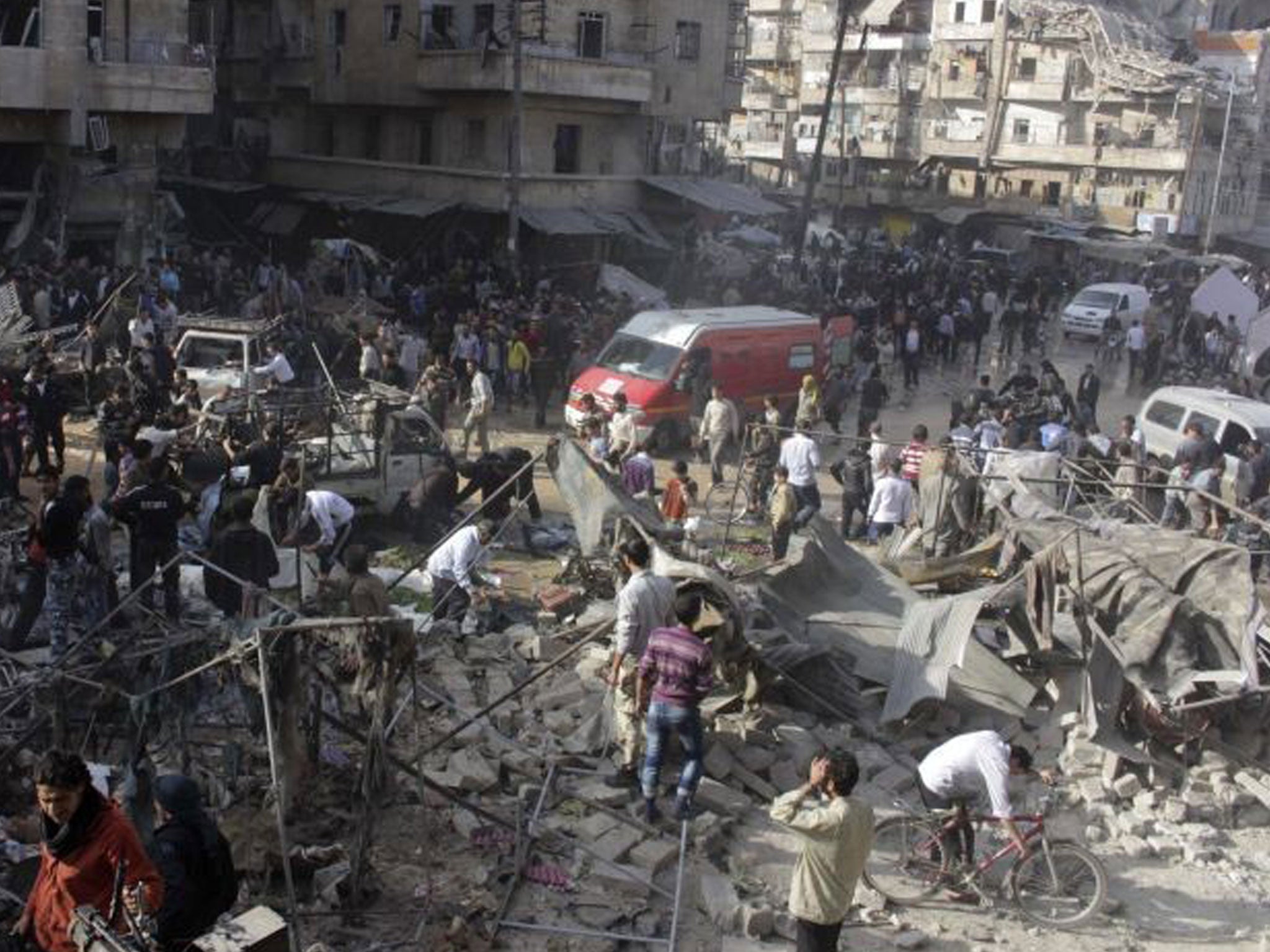People search for survivors amid the rubble of collapsed buildings and tents after what activists said was shelling by forces loyal to Syria's President Bashar al-Assad on a market in Aleppo's Ahalouanah neighbourhood on 23 November.