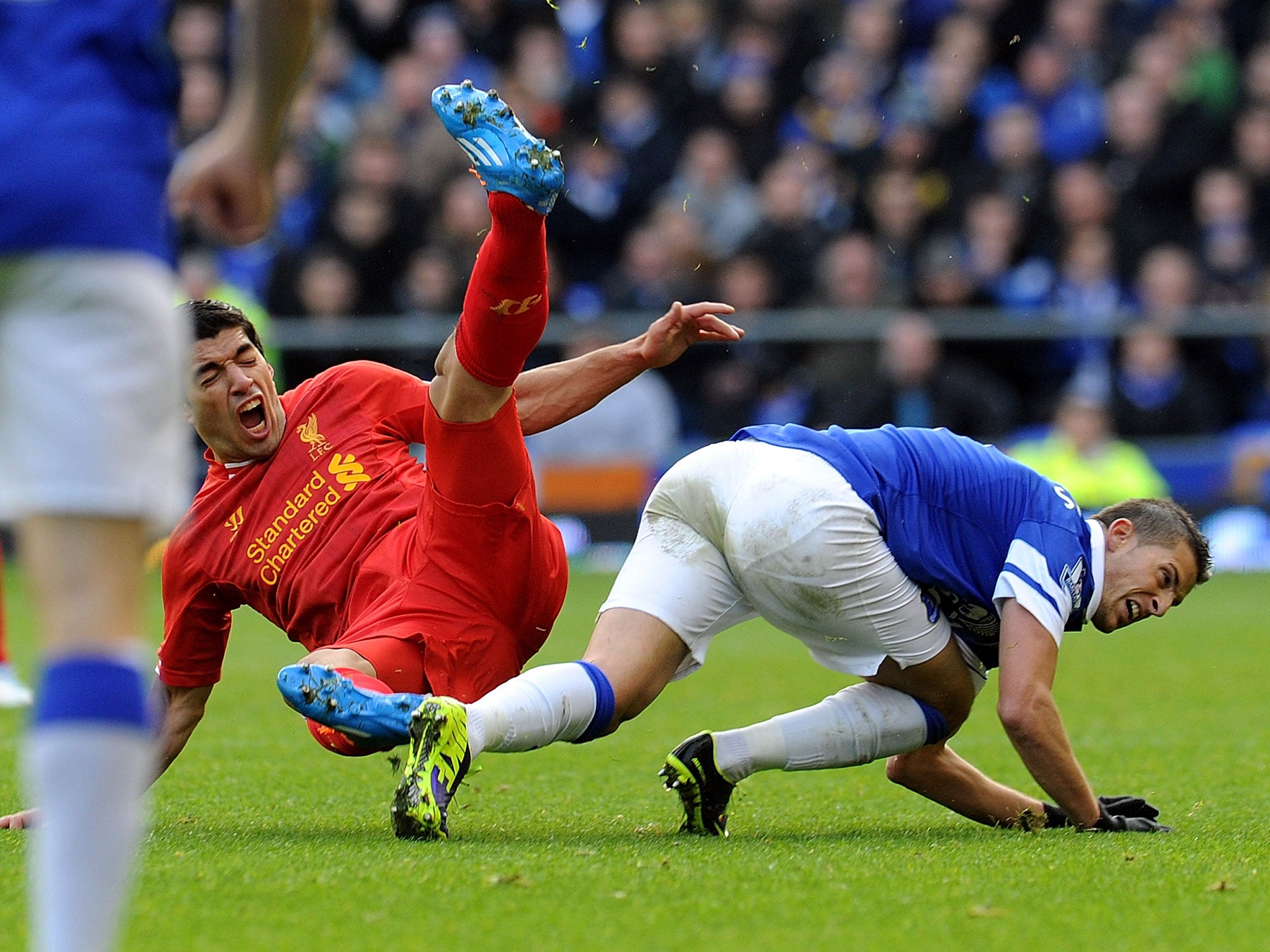 Kevin Mirallas of Everton tackles Luis Suarez of Liverpool