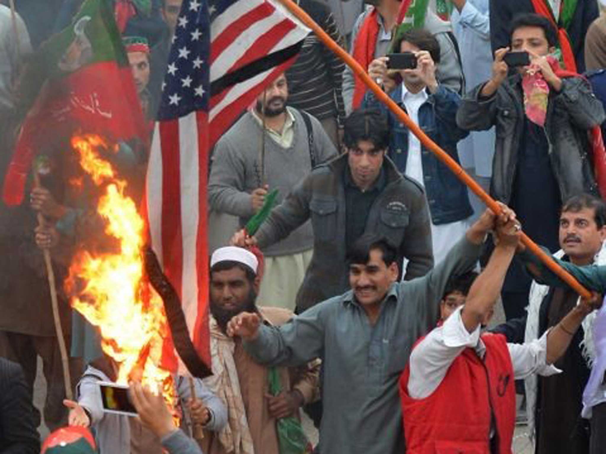 Protesters burn the US flag in Peshawar yesterday