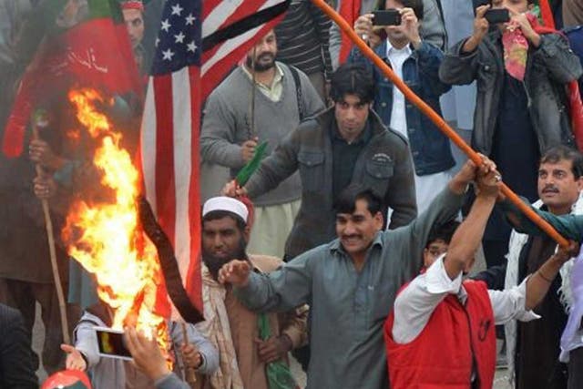 Protesters burn the US flag in Peshawar yesterday