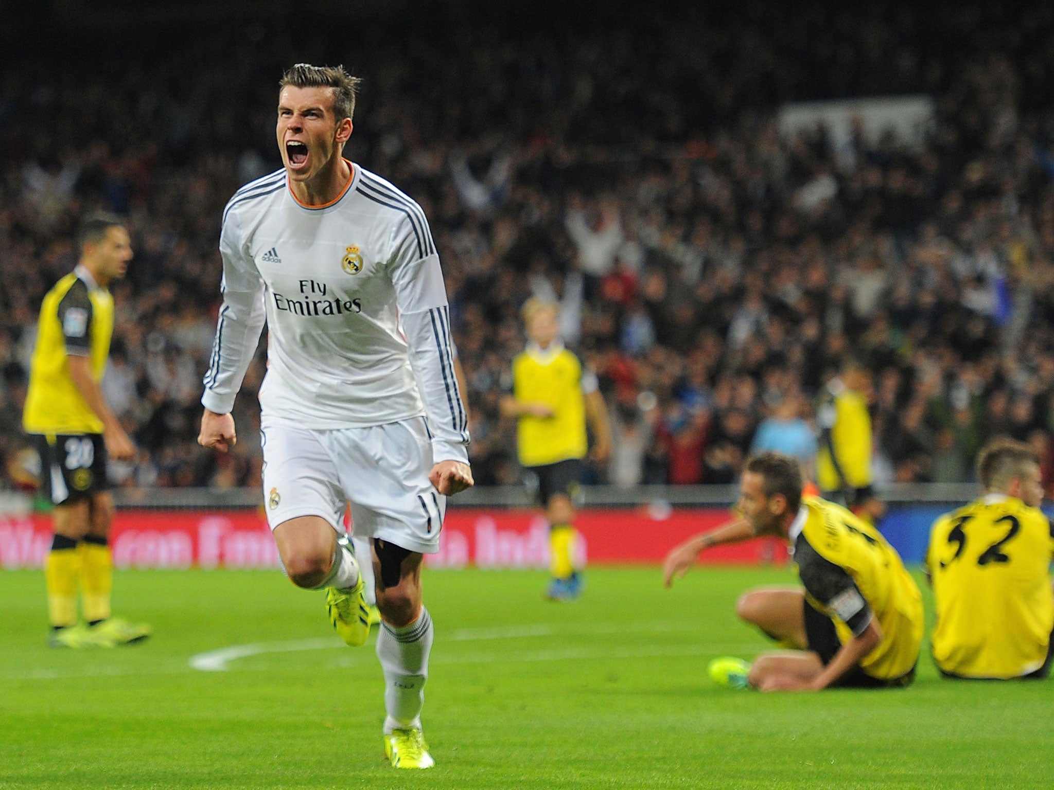 Gareth Bale celebrates after scoring Real's opening goal during the La Liga match between Real Madrid and Sevilla at the Santiago Bernabeu Stadium