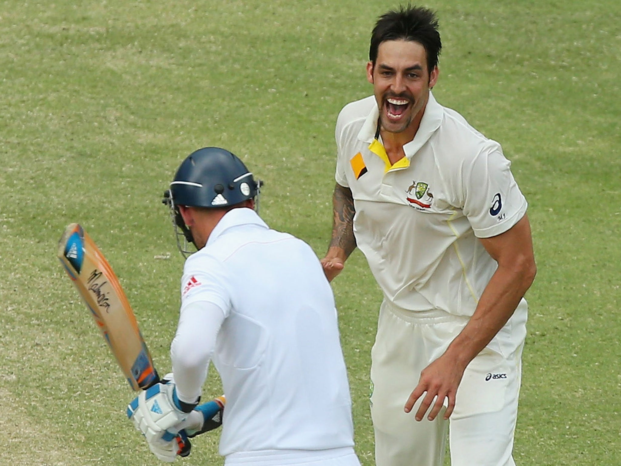Mitchell Johnson of Australia celebrates after taking the wicket of Stuart Broad