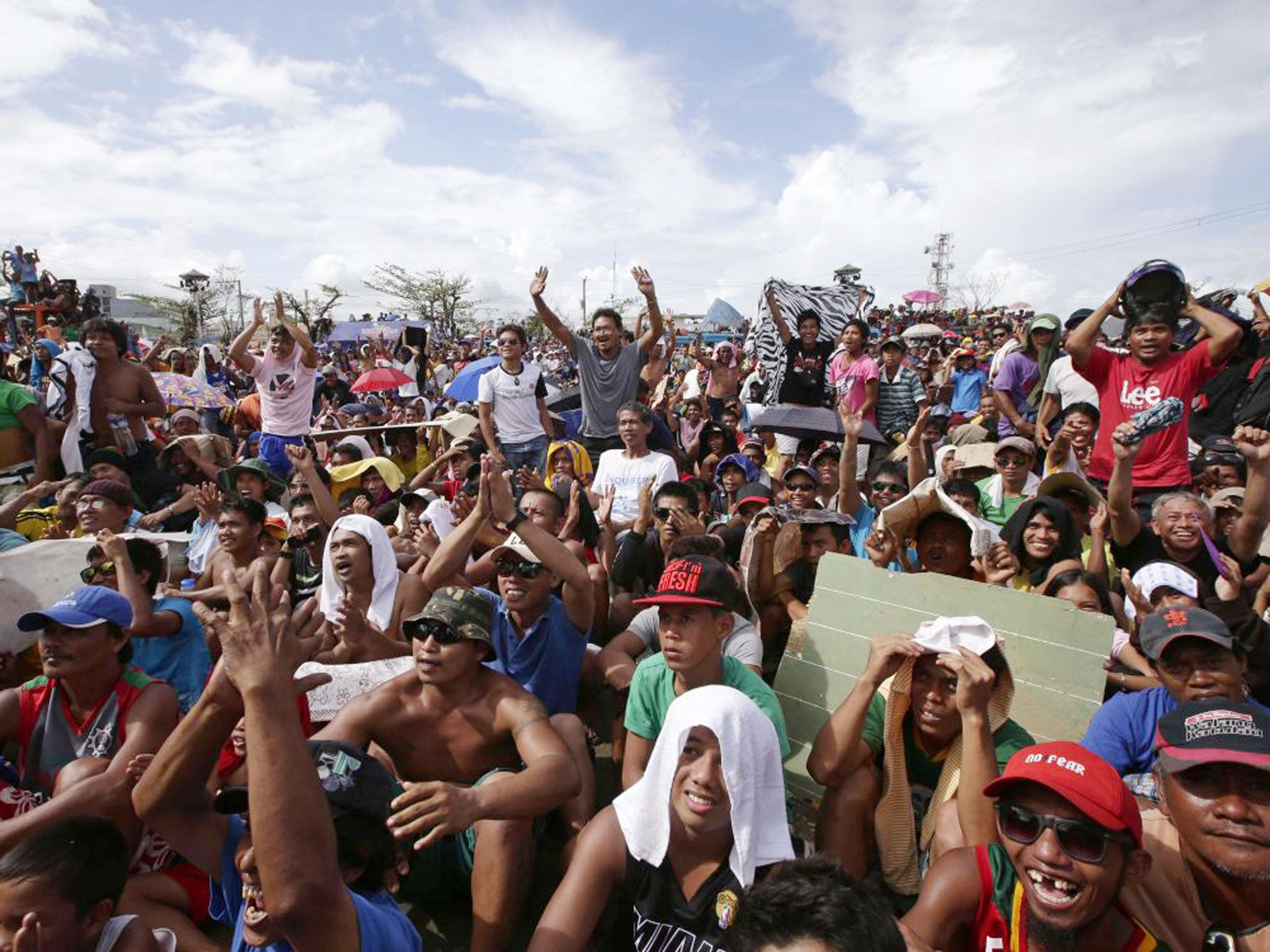 Typhoon survivors in Tacloban city celebrate Manny Pacquiao's win