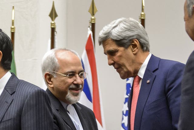 Iran's Foreign Minister Mohammad Javad Zarif shakes hands with US Secretary of State John Kerry in Geneva