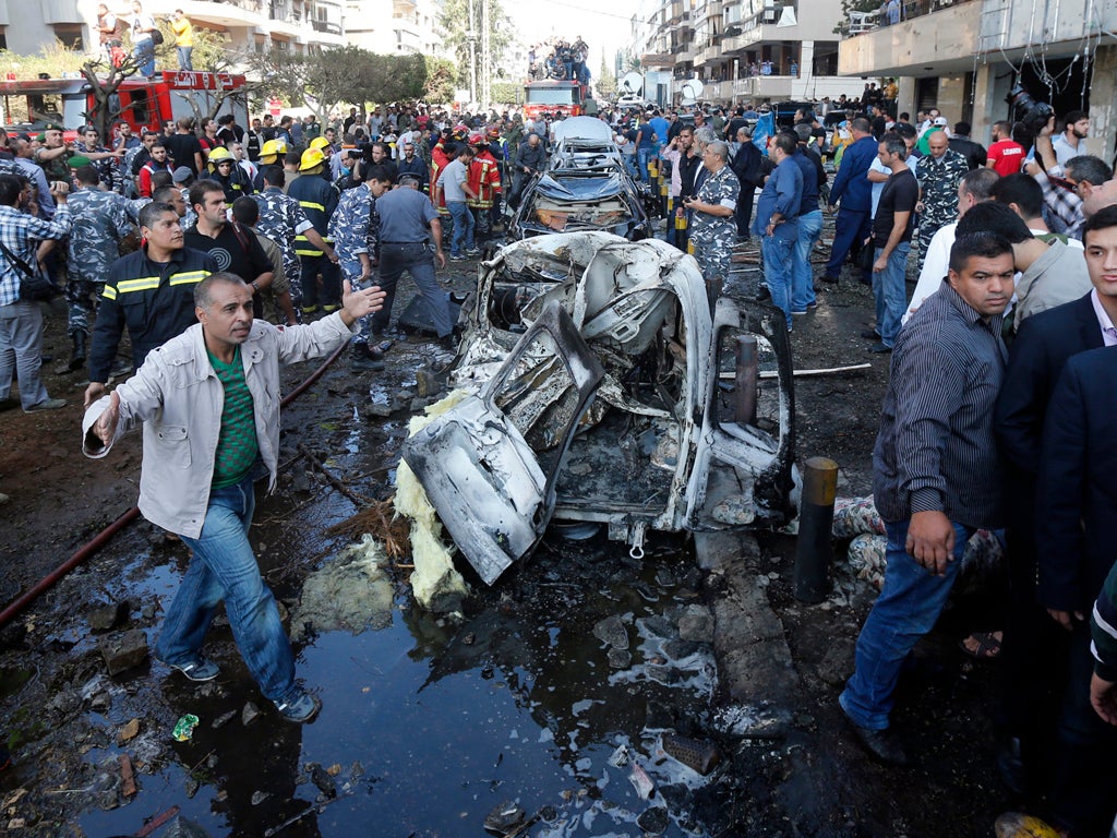 A man gestures at the site of a blast in Bir Hassan neighbourhood in southern Beirut on November 19, 2013.