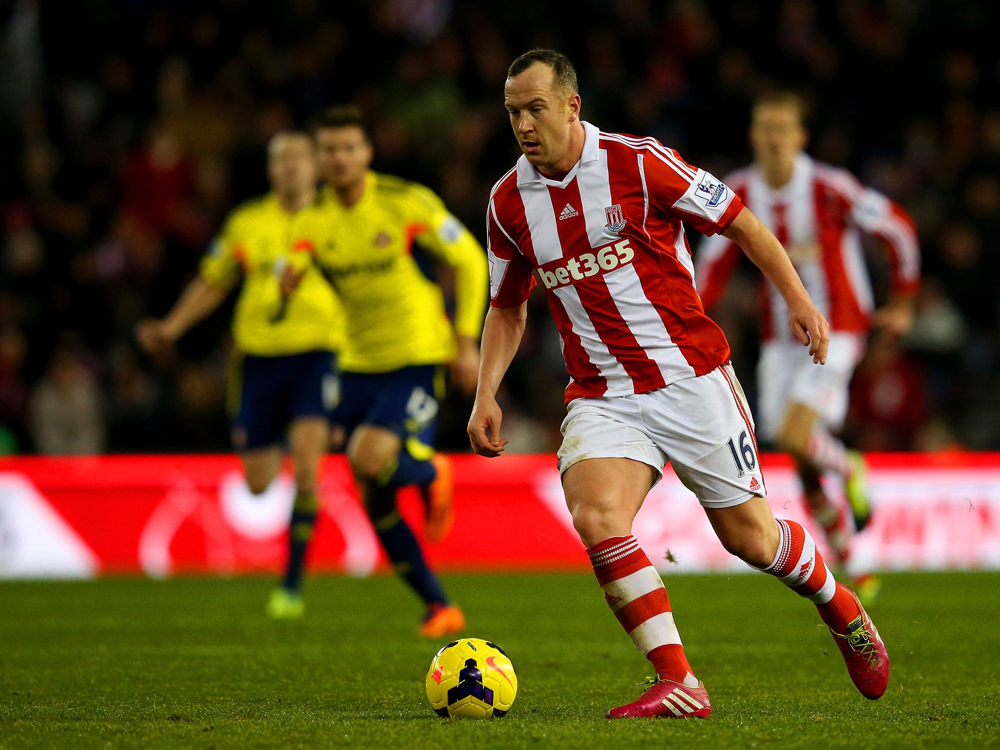 Charlie Adam of Stoke City runs with the ball