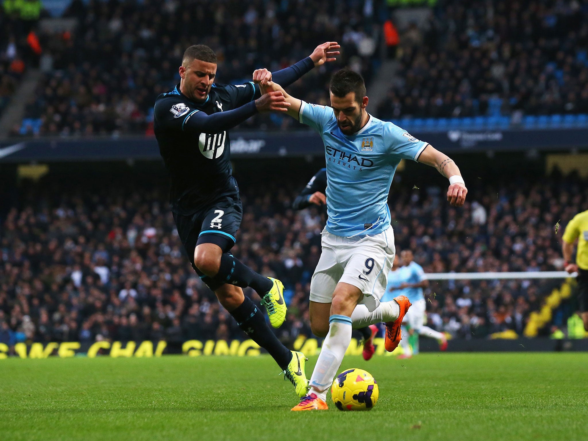 Alvaro Negredo of Manchester City holds off a challenge by Kyle Walker
