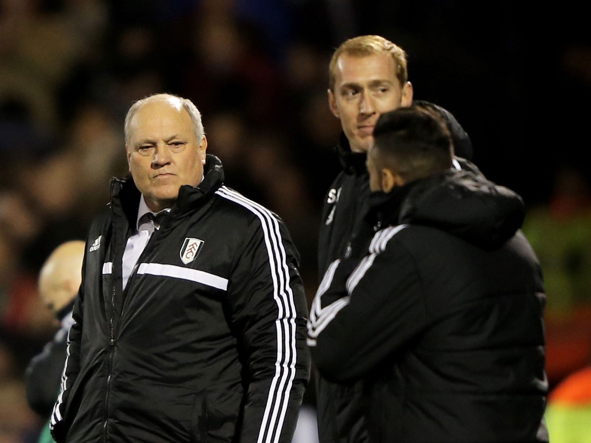 Martin Jol (left) walks off the pitch after Fulham's defeat to Swansea