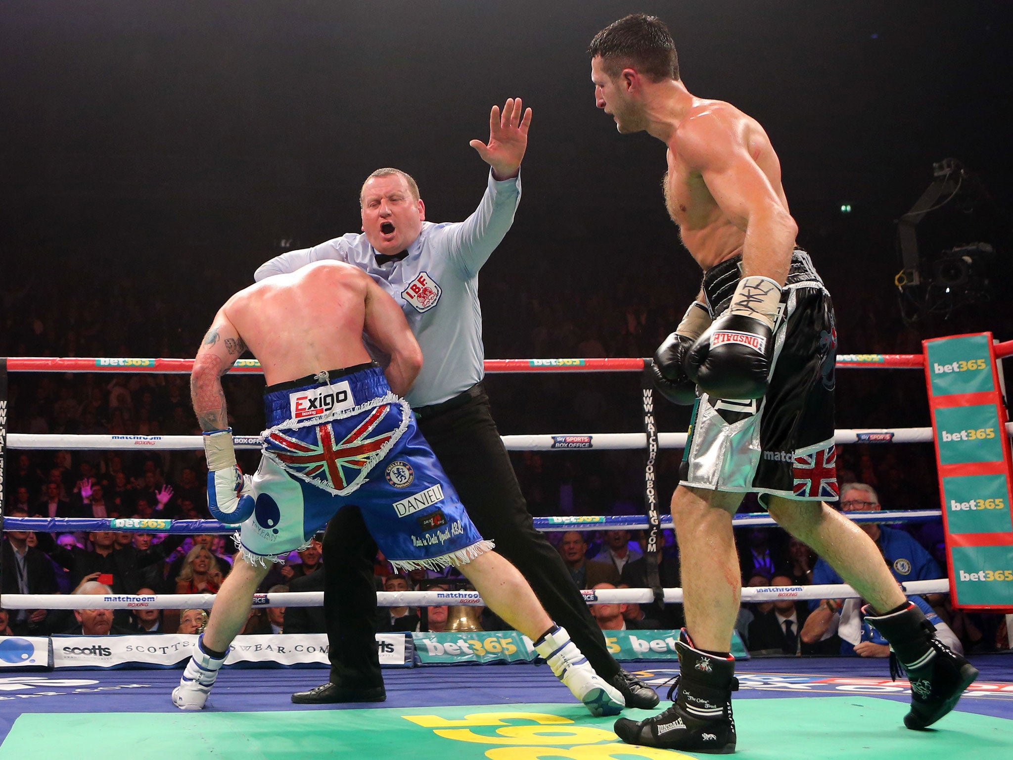 Referee Howard Foster collars George Groves to end the fight against Carl Froch in Manchester