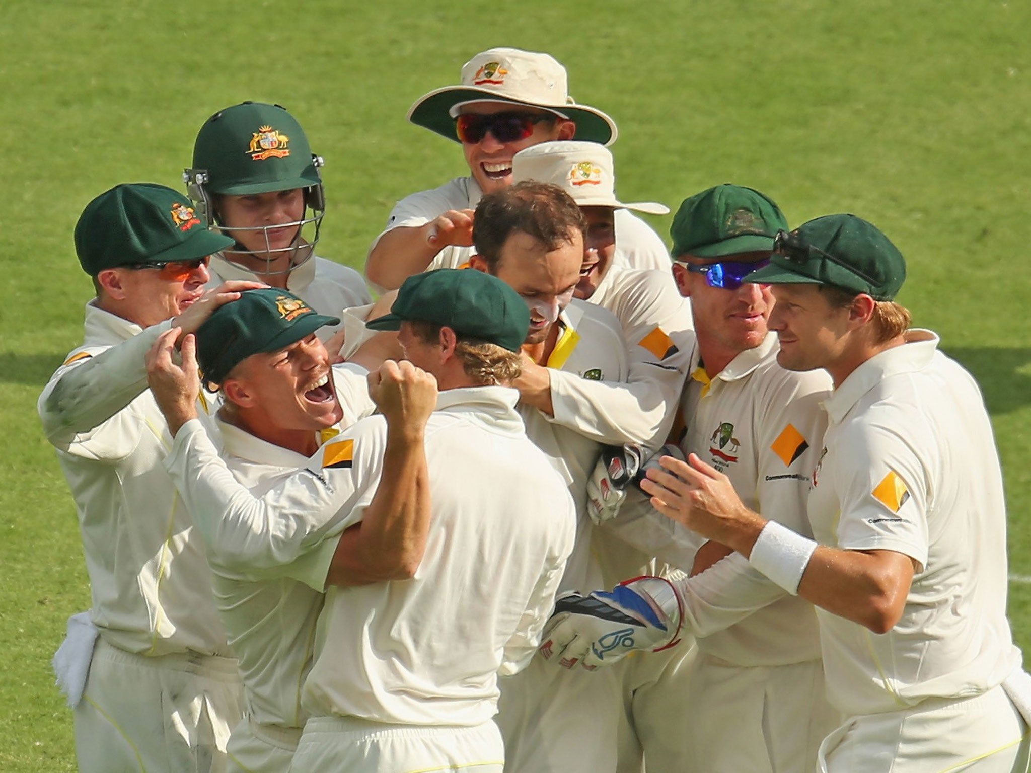The Australian players celebrate another wicket on their way to victory over England
