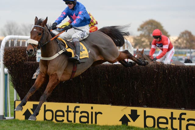 Cue Card puts in a trademark leap for Joe Tizzard in winning the Betfair Chase at Haydock 