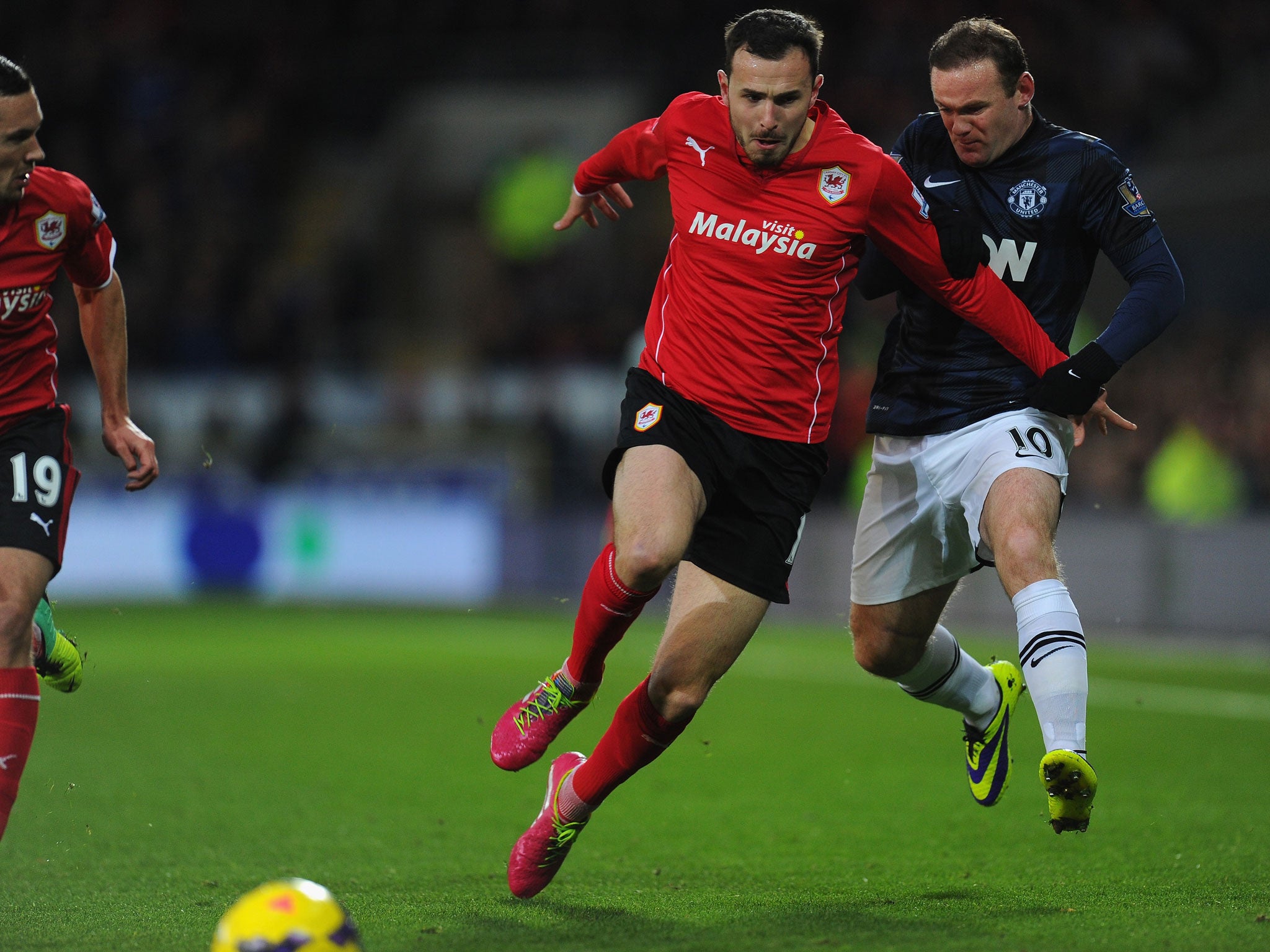 Manchester United striker Wayne Rooney kicks out at Cardiff midfielder Jordon Mutch