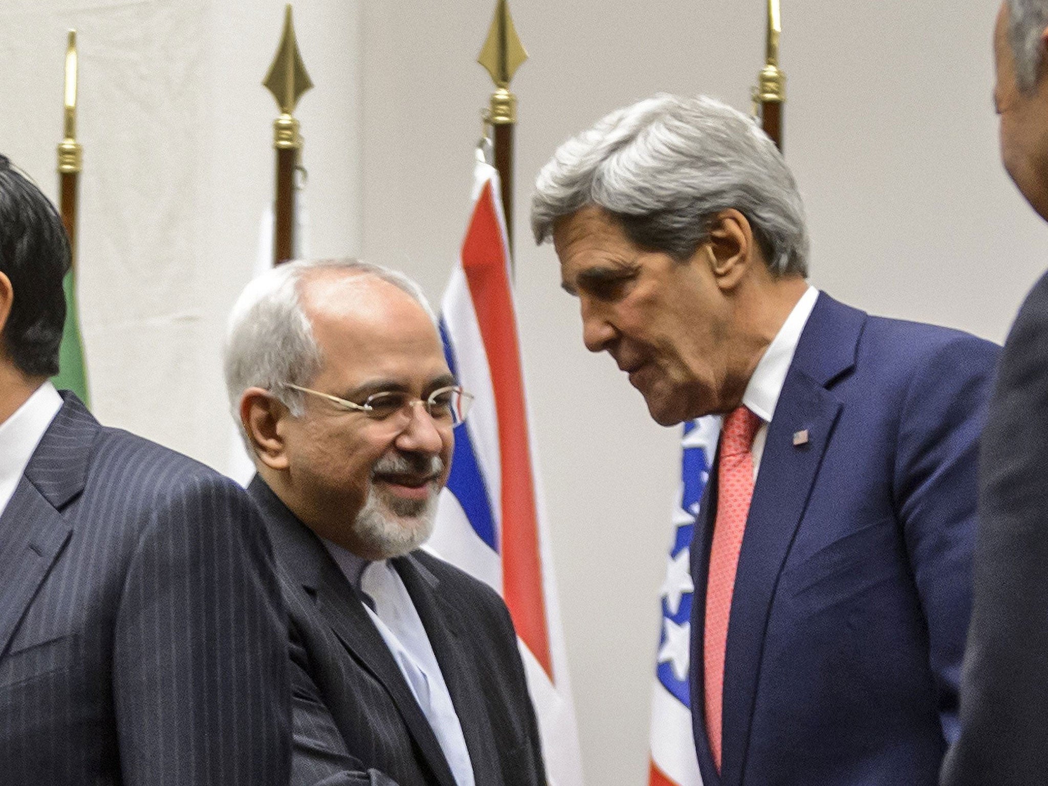 Iran's Foreign Minister Mohammad Javad Zarif shakes hands with US Secretary of State John Kerry in Geneva