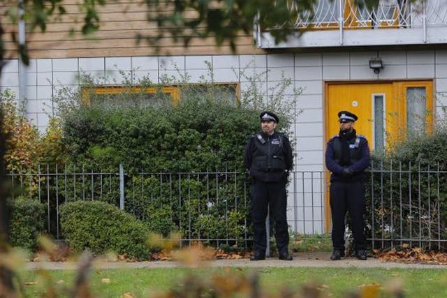 Police guard the flats being investigated in connection with an alleged slavery case
