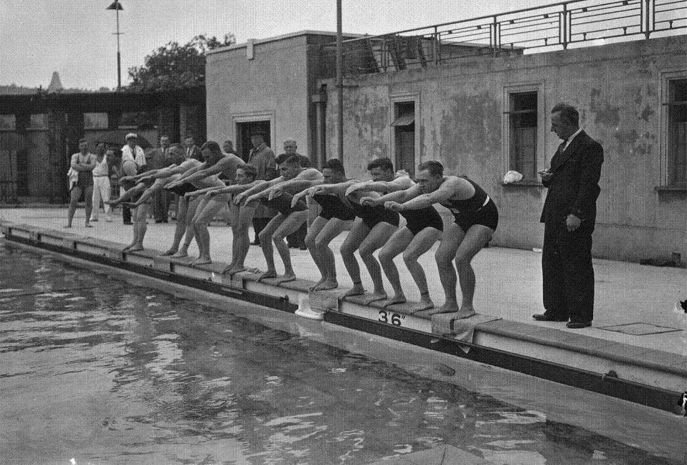 Swimmers line up by the side of the Wood Green pool in 1937