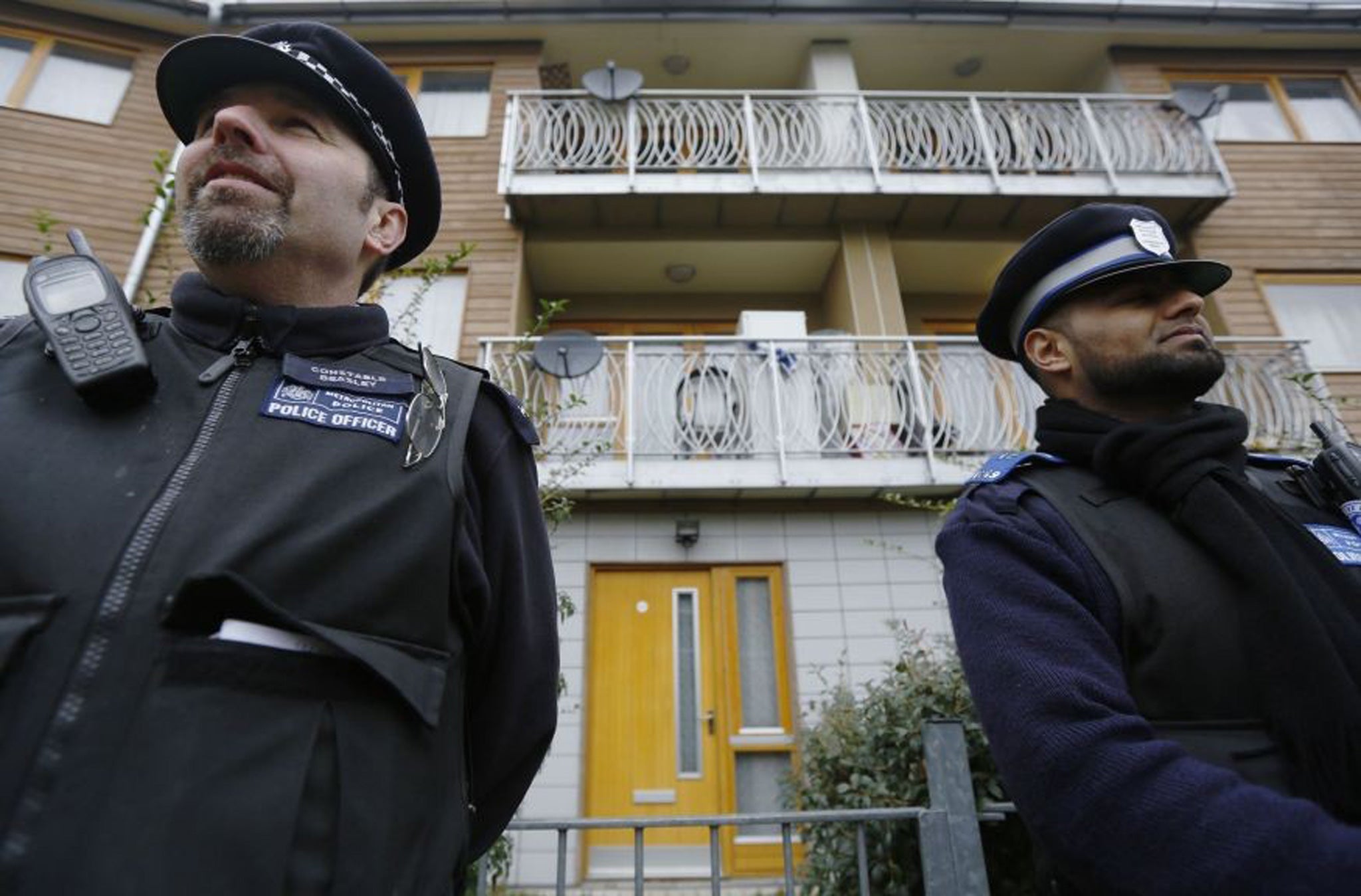 Police stand guard at a property in Brixton, south London, where three women were enslaved in a house in London for 30 years