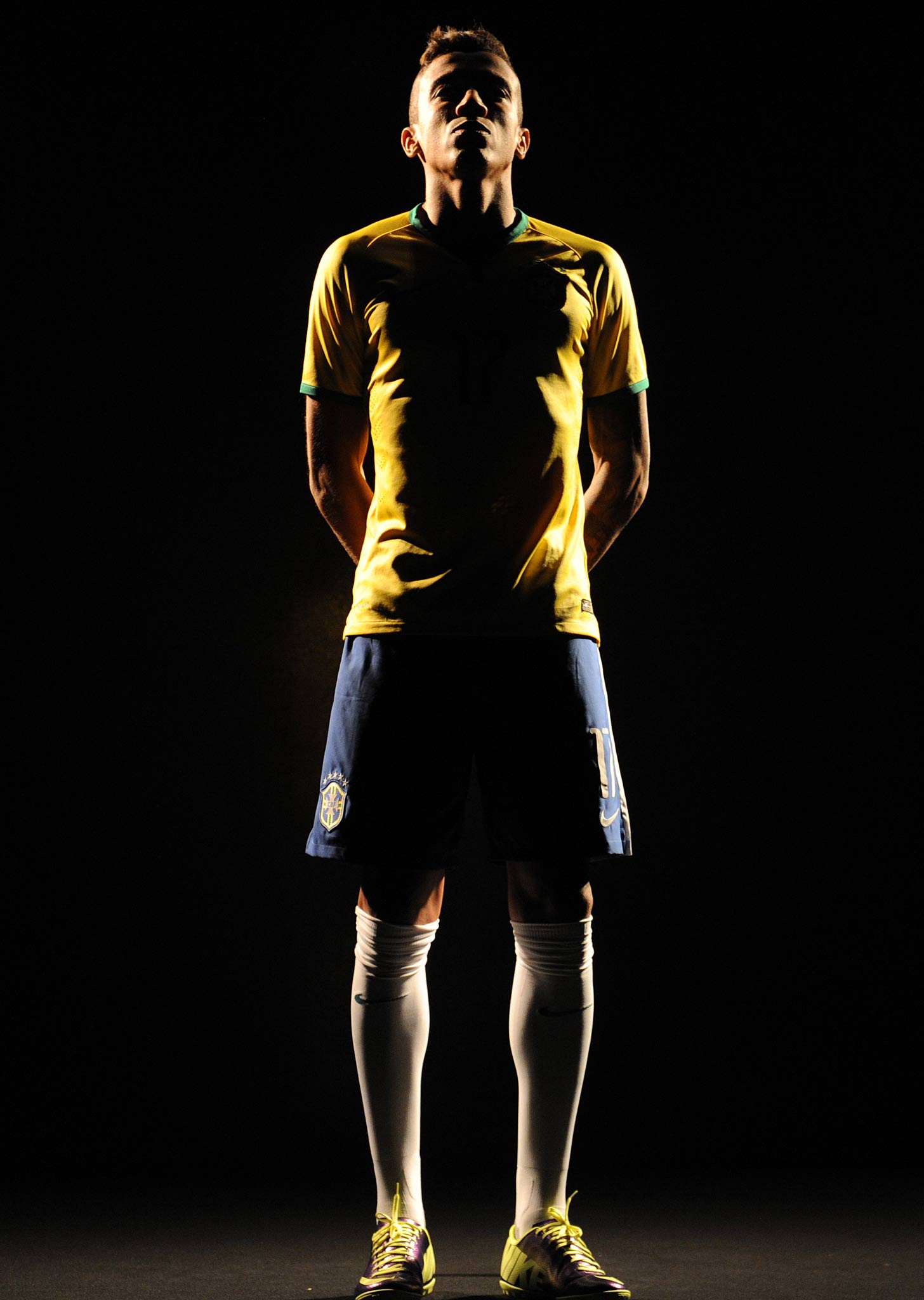 Brazil's Luiz Gustavo poses for pictures during the presentation of the new Brazil kit for the 2014 Fifa World Cup