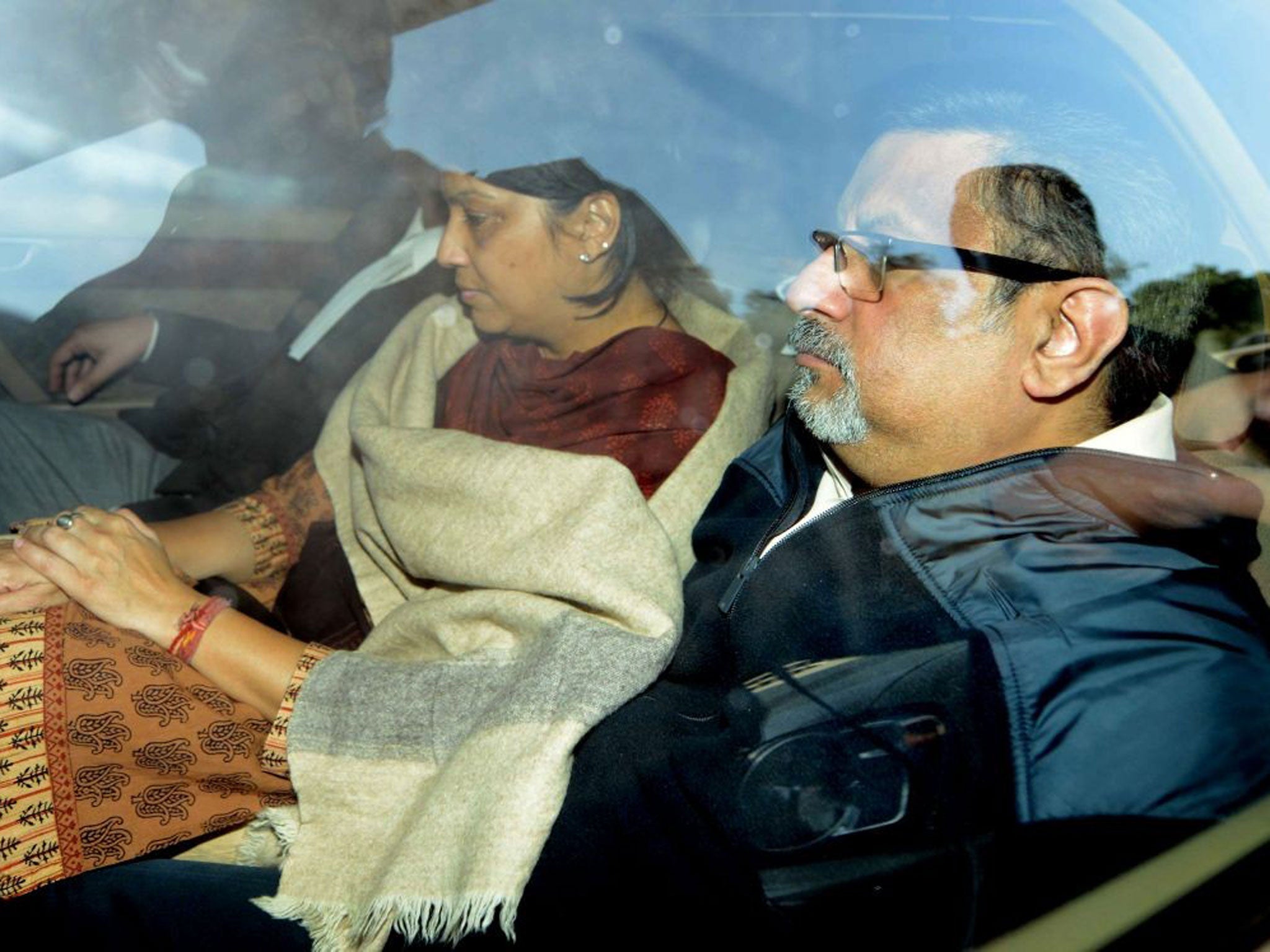 Rajesh Talwar, right, and his wife Nupur, centre, are driven away by Indian police outside a court after their trial for double murder in Ghaziabad, India