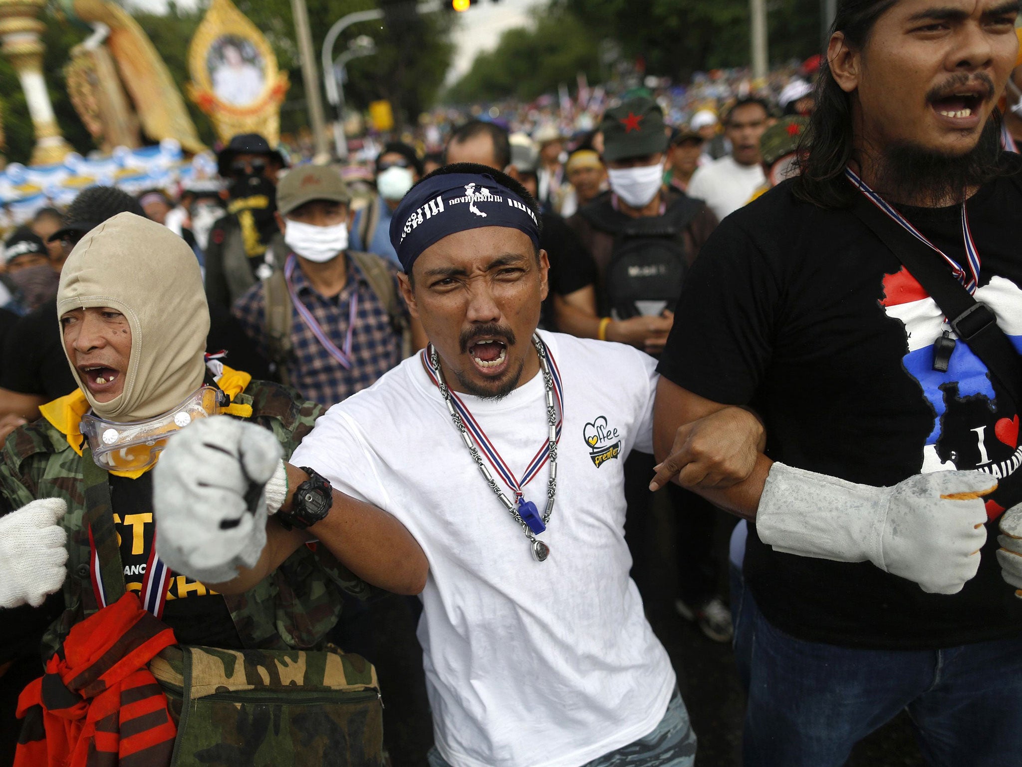 Protesters face a police barricade near the parliament buildings in Bangkok