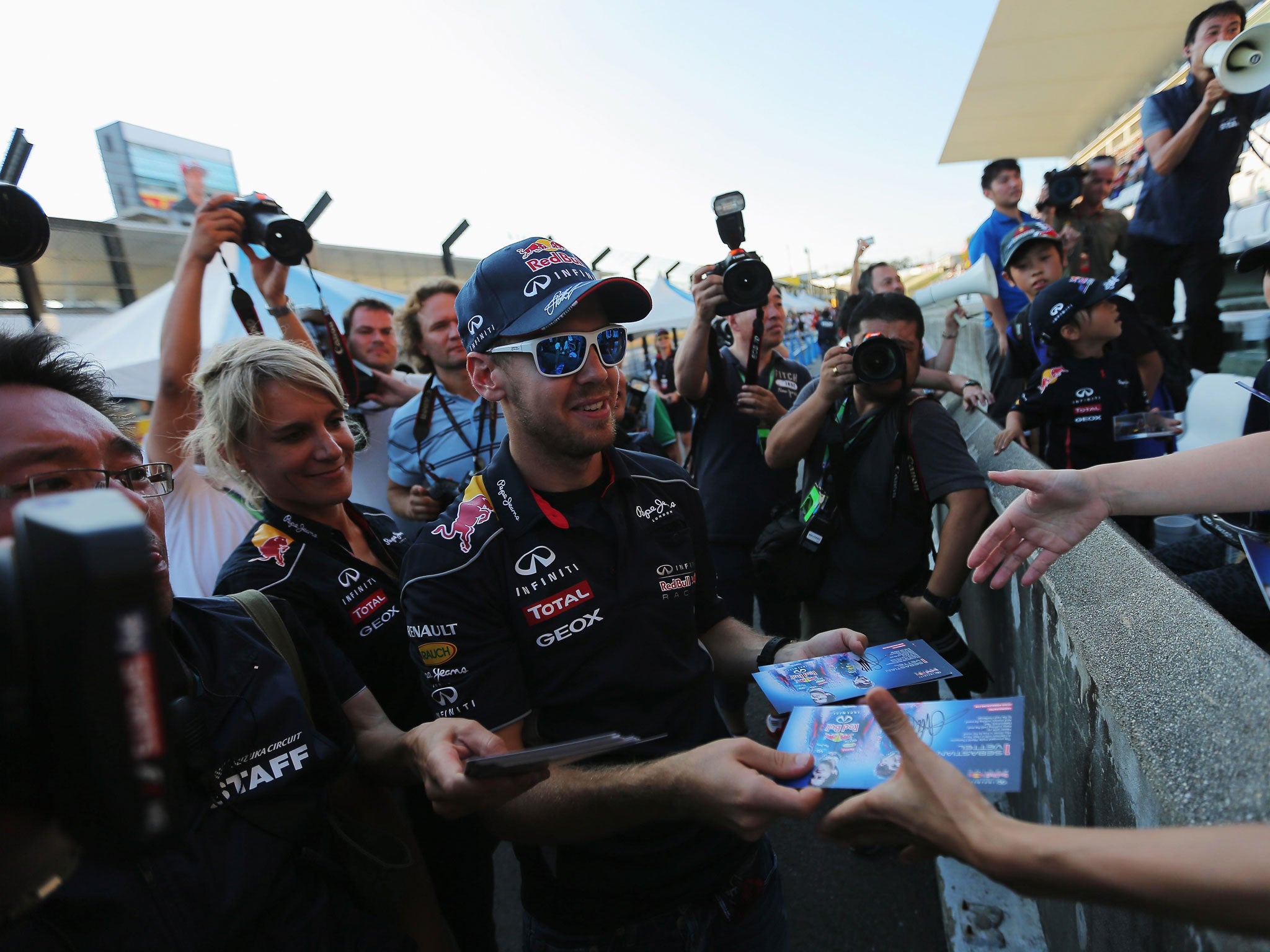 Sebastian Vettel is surrounded by fans ahead of the Japanese Grand Prix last month